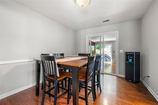 dining area featuring wood finished floors and baseboards