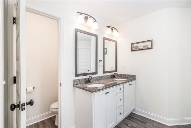 bathroom with vanity, hardwood / wood-style flooring, and toilet