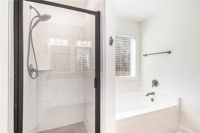 bathroom featuring shower with separate bathtub