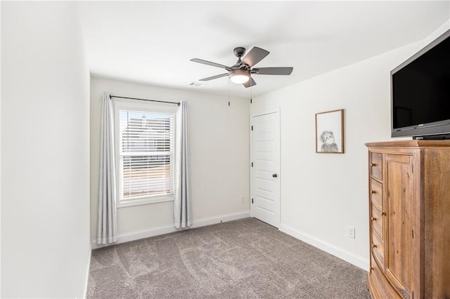 unfurnished bedroom featuring light colored carpet and ceiling fan