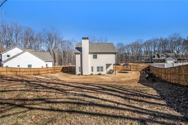 rear view of property featuring a yard