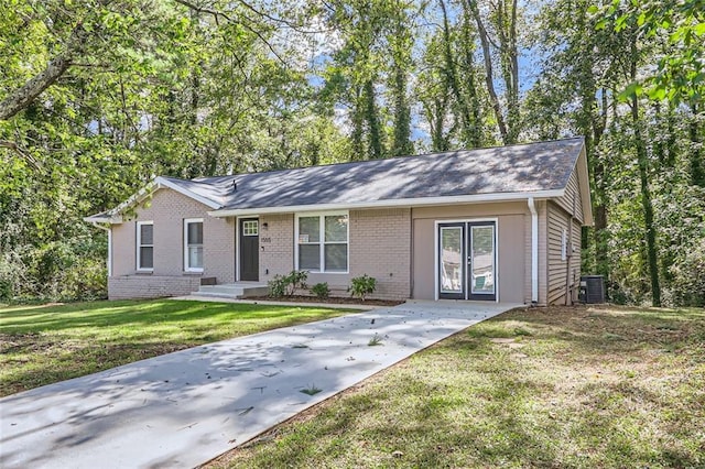 ranch-style house with a front yard and central AC