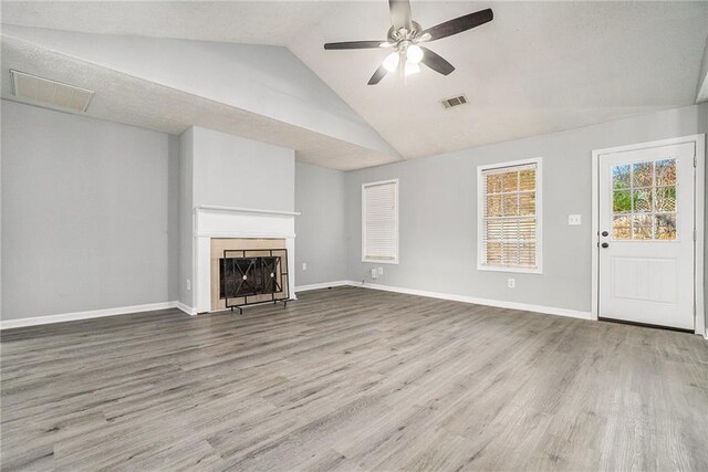 unfurnished living room featuring a textured ceiling, wood-type flooring, high vaulted ceiling, and ceiling fan