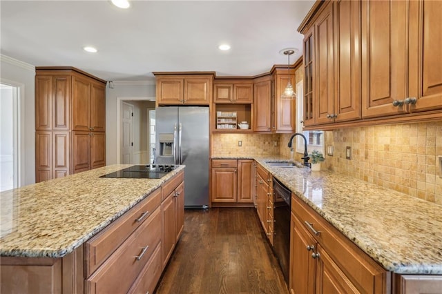 kitchen with brown cabinets, a sink, black appliances, and light stone countertops