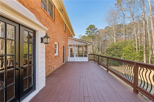 deck with a sunroom and french doors