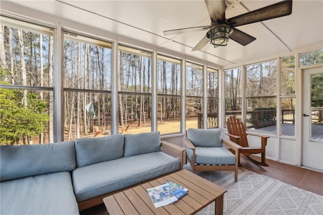 sunroom / solarium featuring a ceiling fan