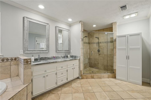 full bath featuring ornamental molding, visible vents, a sink, and a shower stall