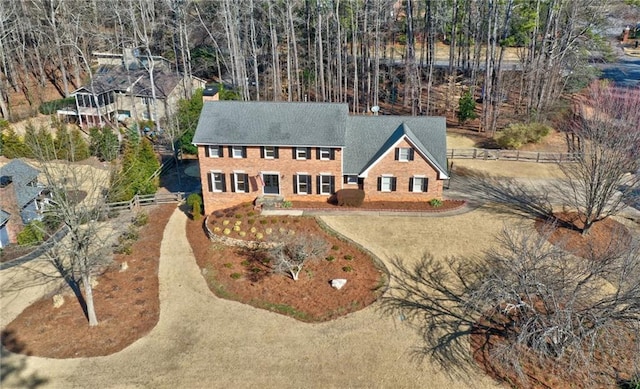 view of front of property featuring brick siding and dirt driveway