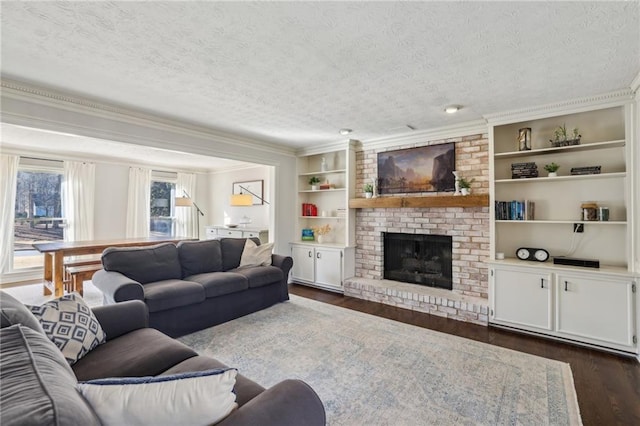 living room with built in features, a fireplace, dark wood finished floors, and a textured ceiling