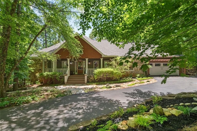 144 Canacaught Pl, Jasper, GA 30143 - view of front of property featuring asphalt driveway, covered porch, and a garage