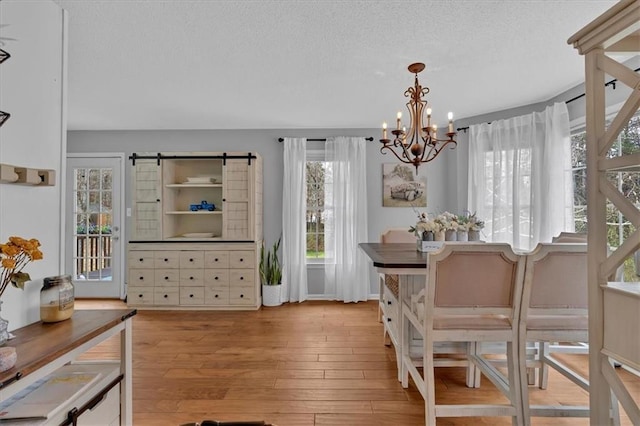 127 Hyde Way, Dallas, GA 30157 - dining room with hardwood / wood-style floors, a textured ceiling, and a notable chandelier