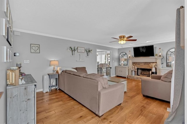 127 Hyde Way, Dallas, GA 30157 - living room featuring crown molding, a ceiling fan, a stone fireplace, and light wood-type flooring