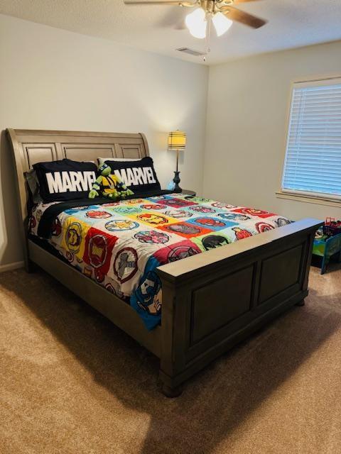 bedroom featuring ceiling fan and carpet floors