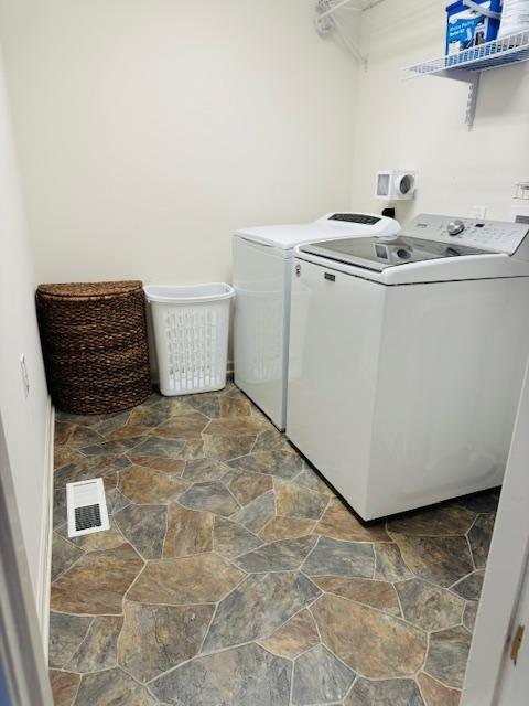 washroom with washer and dryer