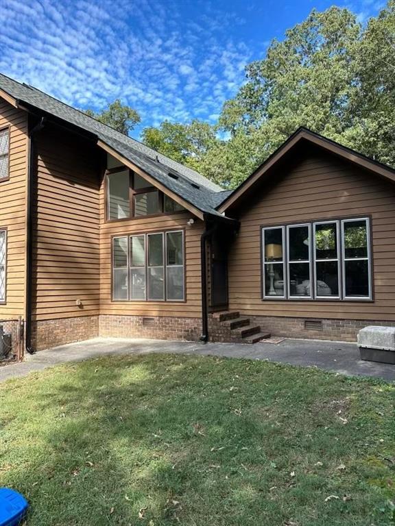 rear view of property with a yard