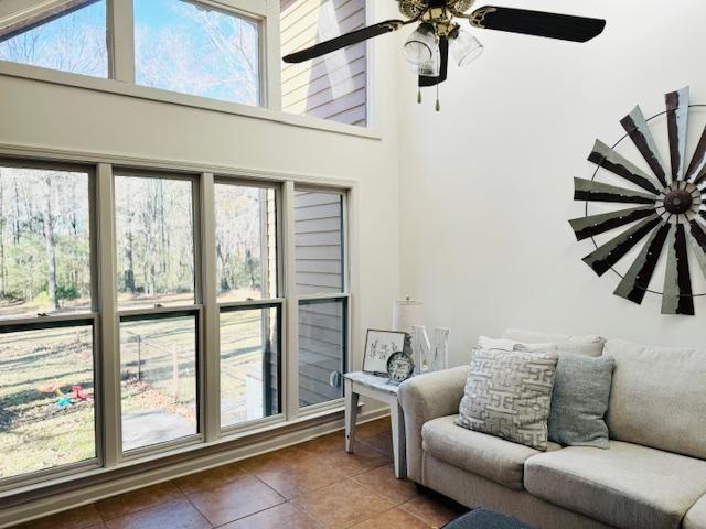 sunroom featuring ceiling fan and a healthy amount of sunlight