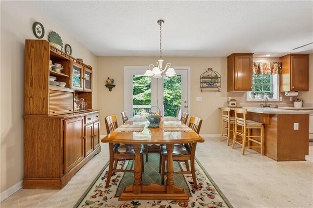 6960 Worley Rd, Cumming, GA 30028 - dining space featuring healthy amount of natural light, a chandelier, and baseboards