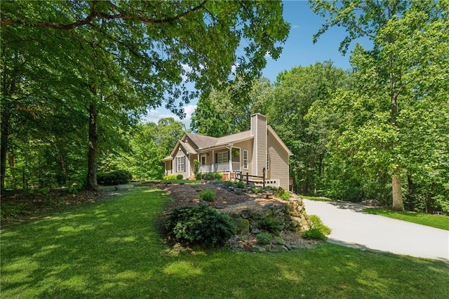 6960 Worley Rd, Cumming, GA 30028 - view of front of home featuring a porch, a front lawn, a chimney, and driveway