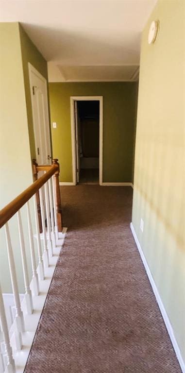 hall with carpet and baseboards