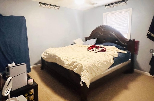 bedroom with carpet and baseboards