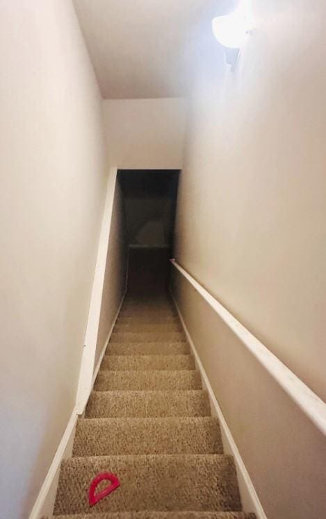 stairway featuring baseboards