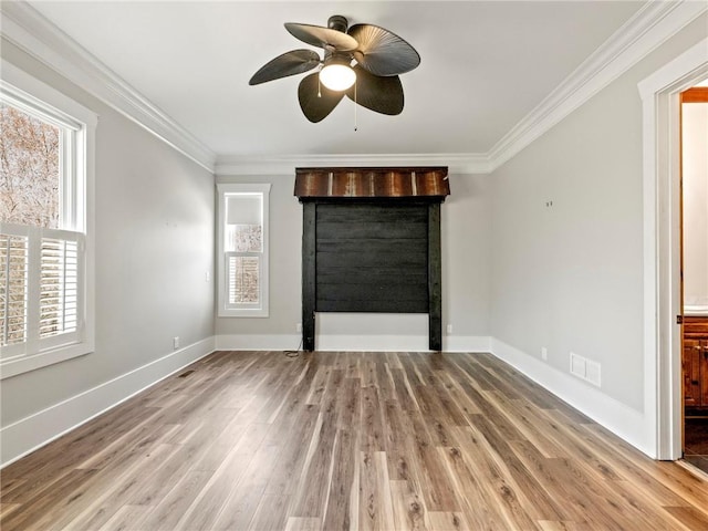 unfurnished living room with light wood-style flooring, visible vents, baseboards, and ornamental molding