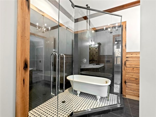 bathroom featuring a stall shower, tile patterned flooring, a chandelier, and tile walls