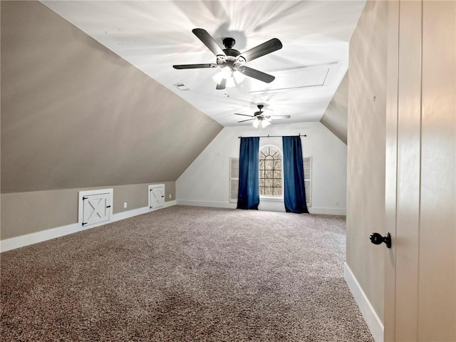 additional living space featuring carpet floors, visible vents, vaulted ceiling, and baseboards