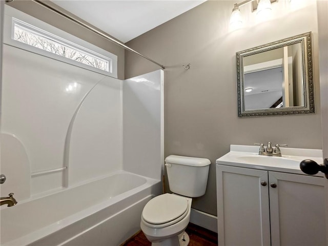 full bath featuring bathtub / shower combination, baseboards, vanity, and toilet