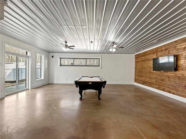 recreation room with ceiling fan, concrete floors, billiards, and wooden walls