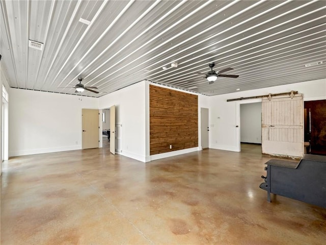 garage with ceiling fan, visible vents, and baseboards