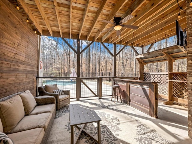 view of patio / terrace with ceiling fan, fence, and outdoor lounge area