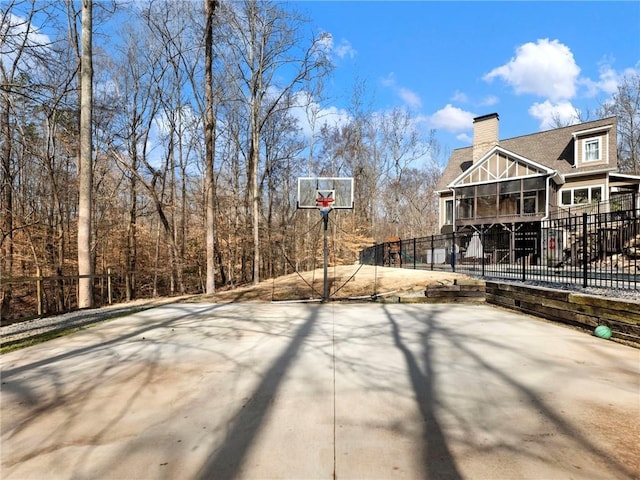 view of basketball court with basketball court and fence