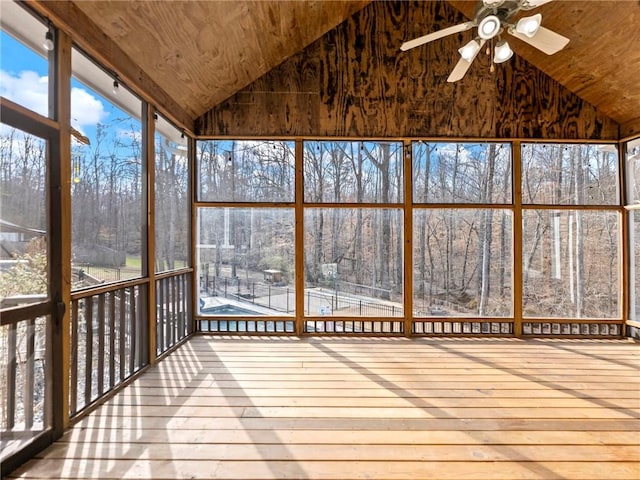 unfurnished sunroom with lofted ceiling, wooden ceiling, and a ceiling fan