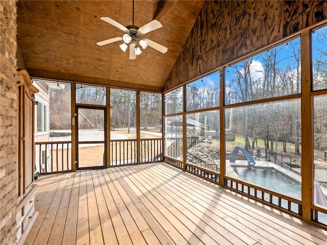 unfurnished sunroom featuring lofted ceiling and a ceiling fan