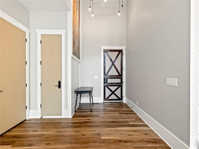 interior space with baseboards and wood finished floors