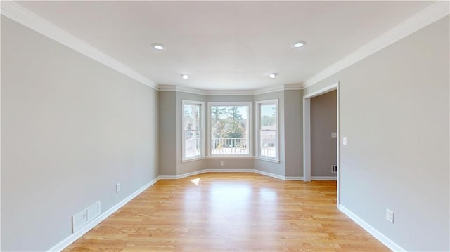 empty room with visible vents, recessed lighting, crown molding, light wood finished floors, and baseboards