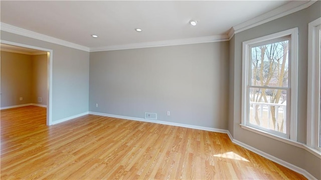 spare room featuring visible vents, plenty of natural light, and baseboards