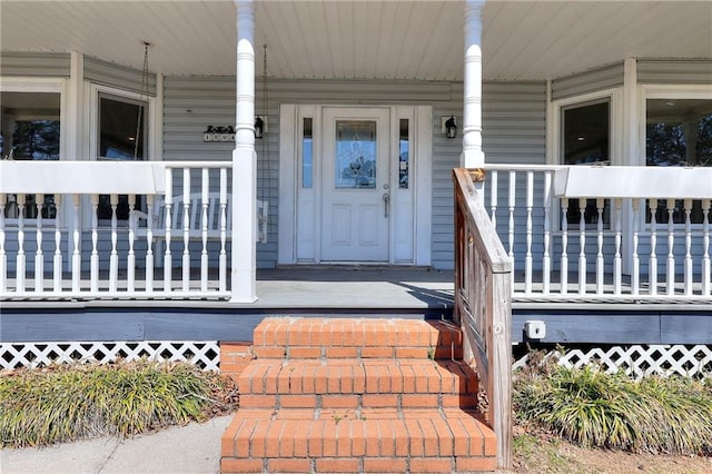 view of exterior entry with a porch