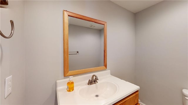 bathroom with toilet and vanity