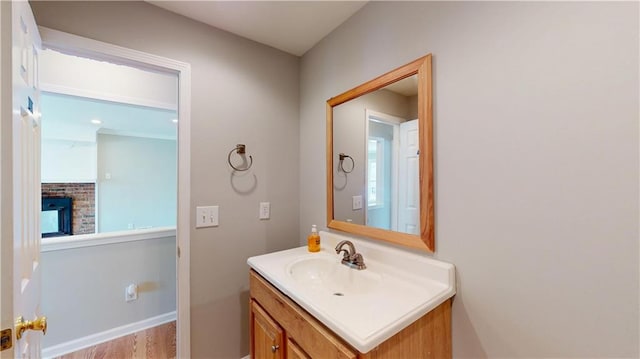 bathroom with a brick fireplace and vanity