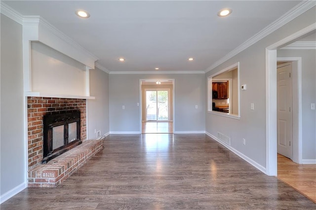 unfurnished living room featuring wood finished floors, recessed lighting, a fireplace, crown molding, and baseboards