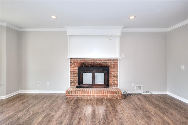 unfurnished living room with visible vents, baseboards, ornamental molding, a fireplace, and wood finished floors