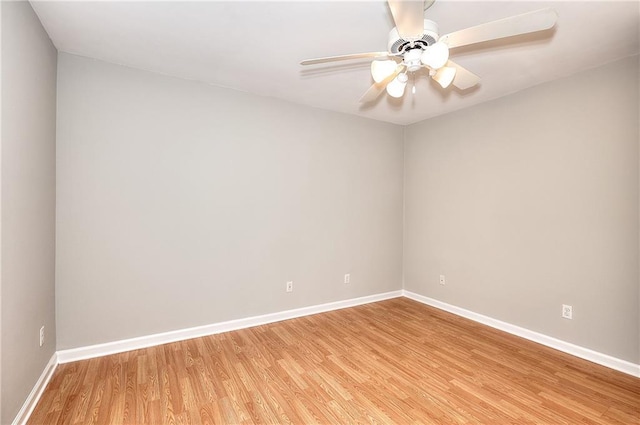 unfurnished room featuring a ceiling fan, baseboards, and light wood-type flooring