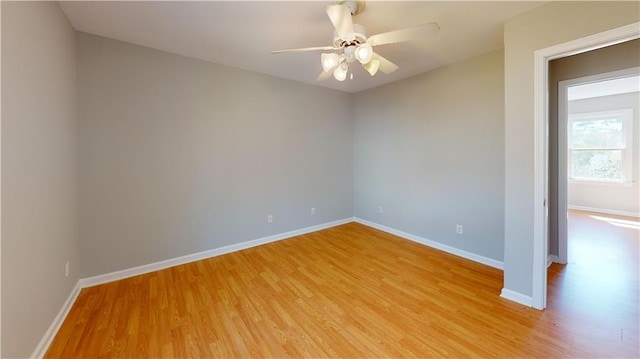 unfurnished room featuring baseboards, ceiling fan, and light wood finished floors