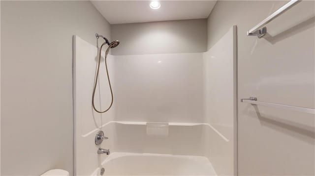 bathroom featuring shower / tub combination and toilet