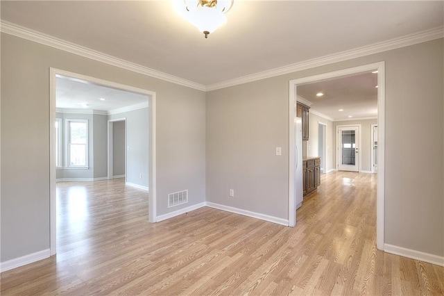 unfurnished room featuring visible vents, baseboards, and light wood-style flooring