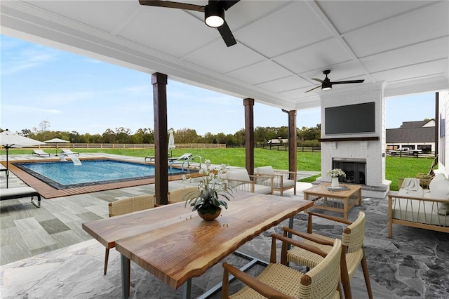 view of patio featuring ceiling fan and an outdoor brick fireplace