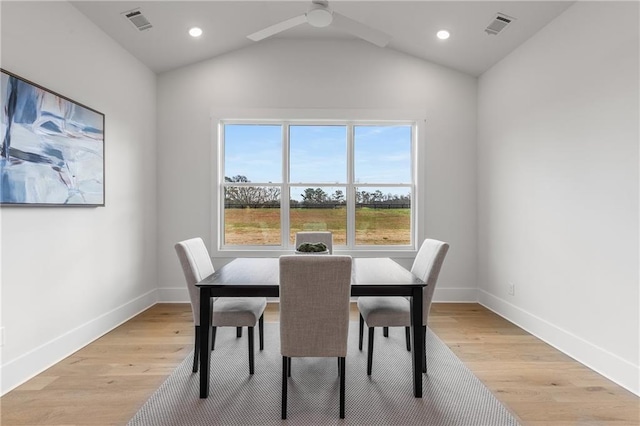 dining room with ceiling fan, light wood-type flooring, and lofted ceiling