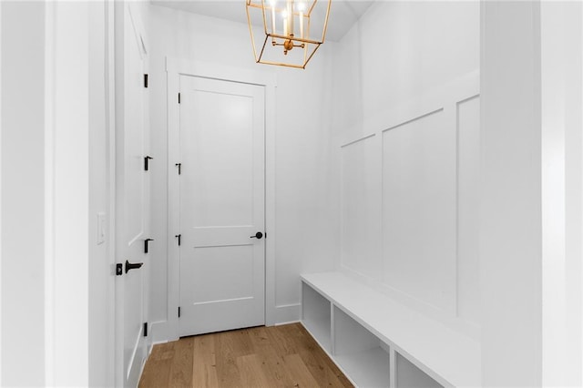 mudroom featuring an inviting chandelier and light wood-type flooring